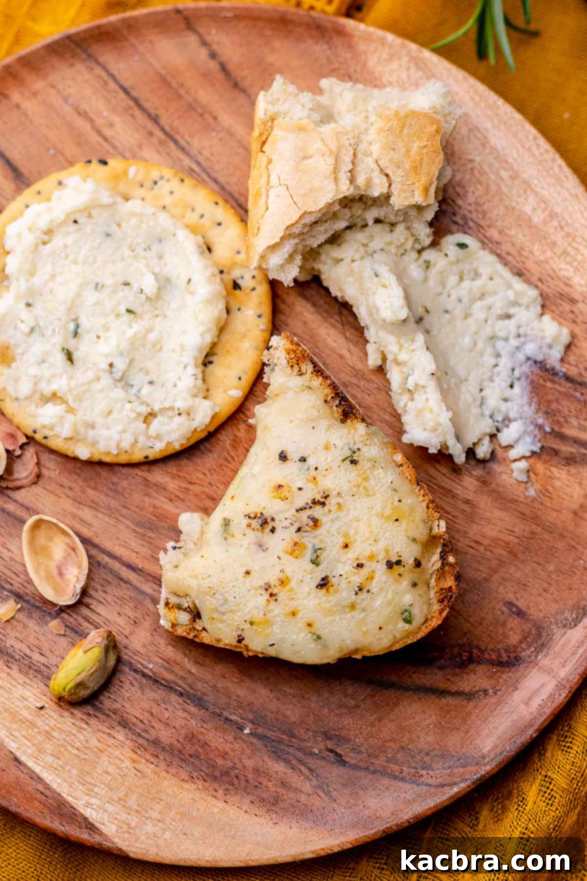 Potent French Cheese Spread 8 A plate featuring Fromage Fort alongside slices of baguette and various crackers.