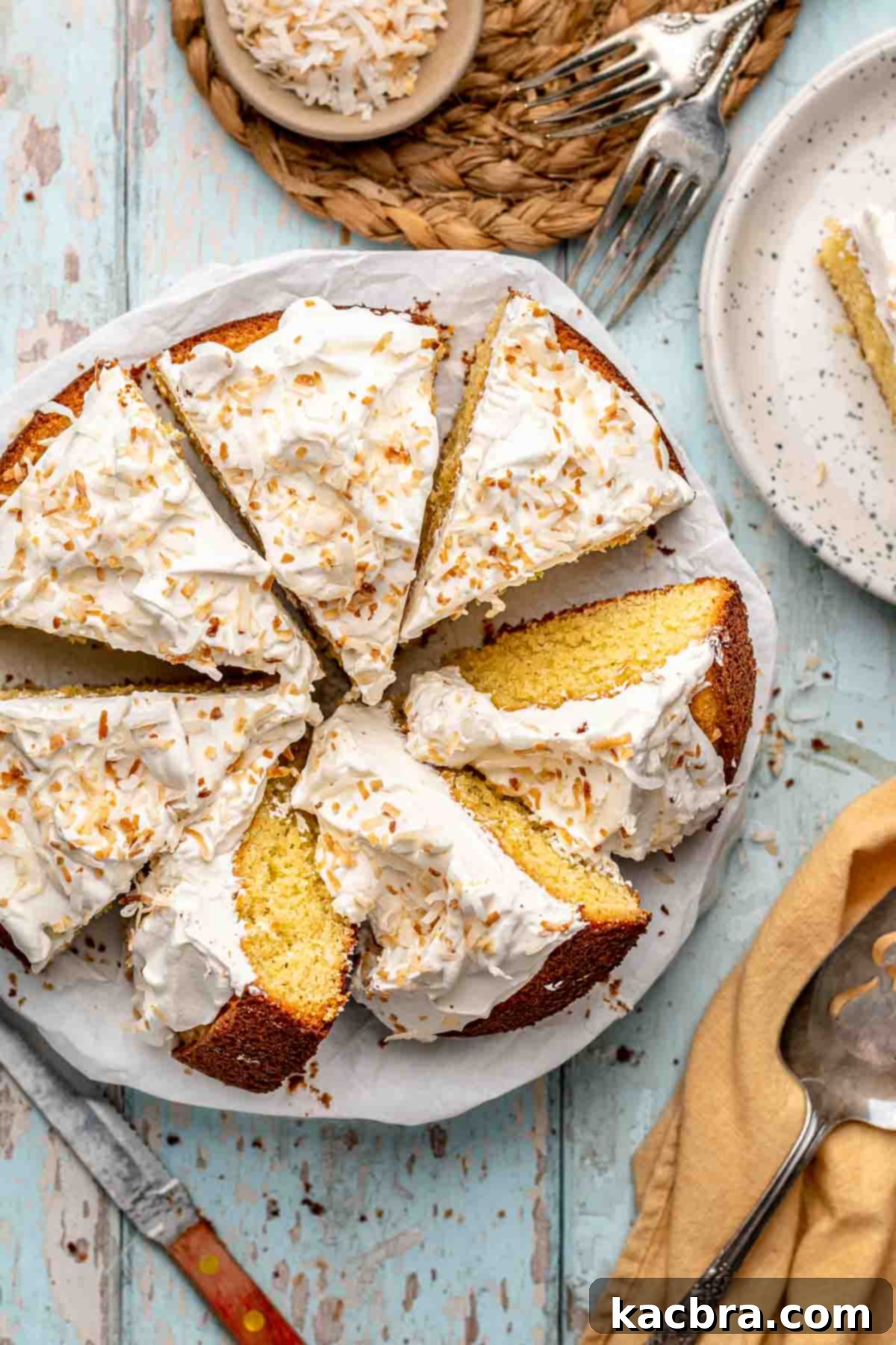 Sliced coconut almond cake presented beautifully on a platter.