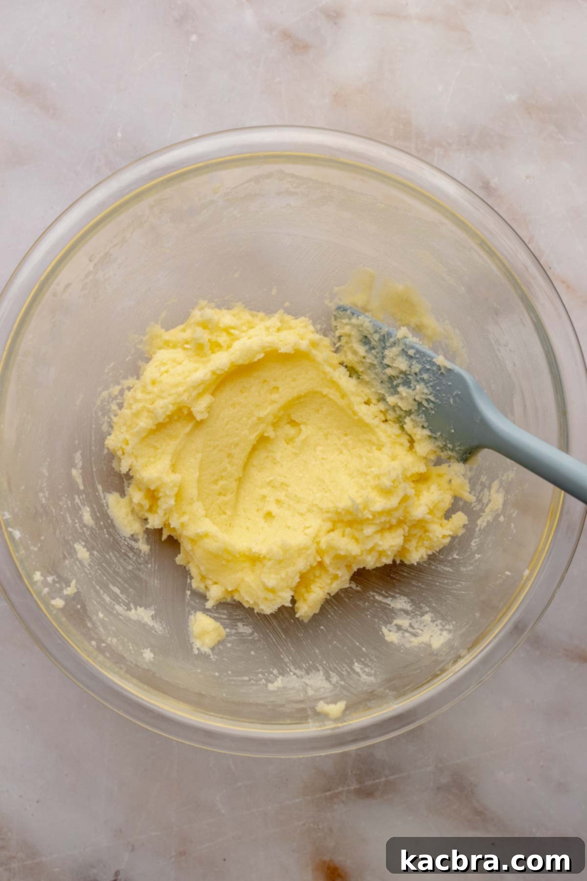 Creamed butter and sugar in a bowl, light and fluffy.