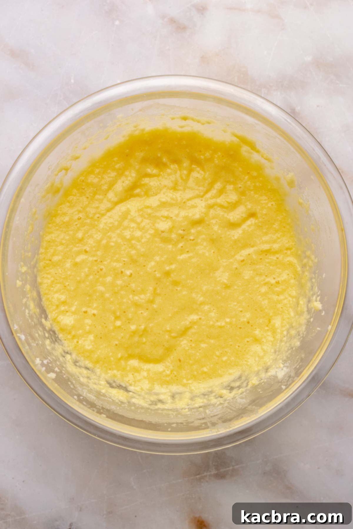 Cake batter base in a bowl, ready for dry ingredients.