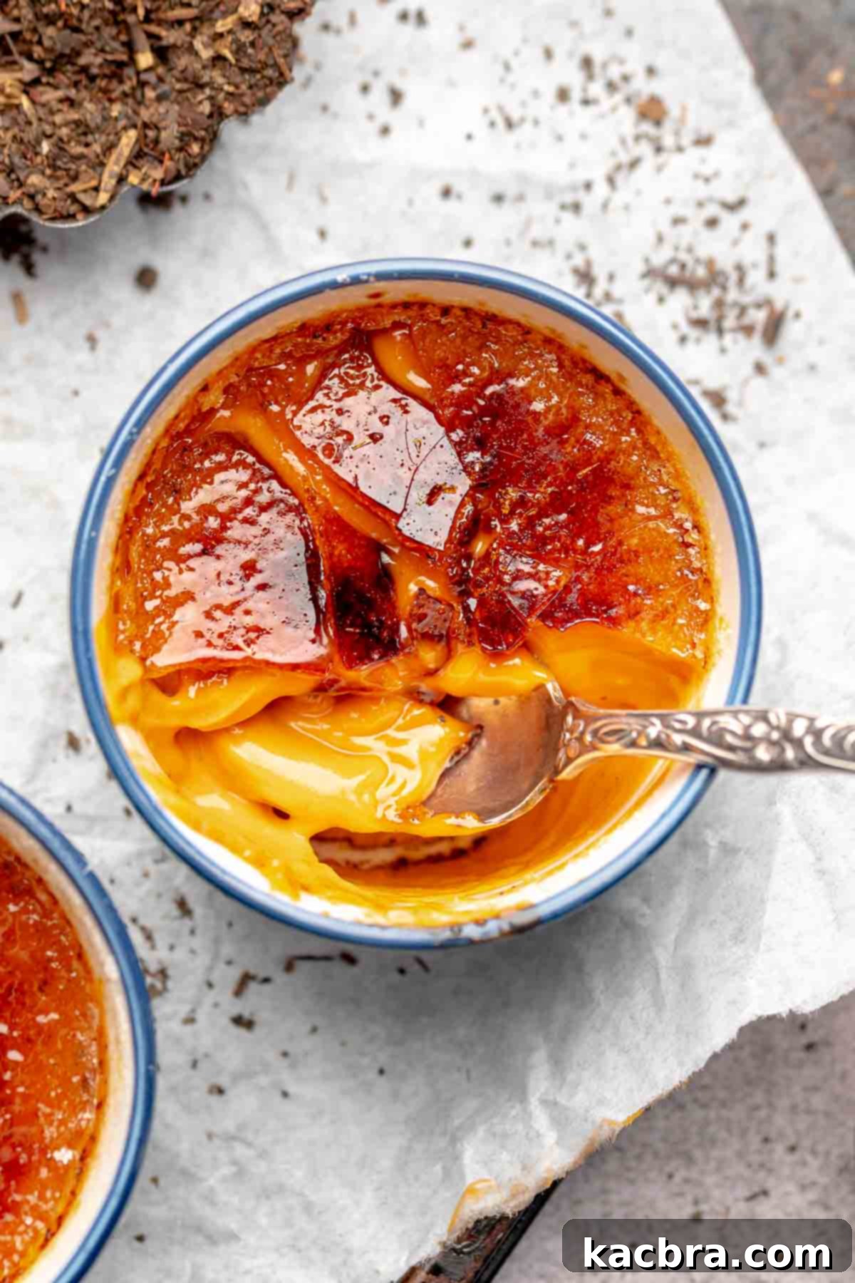 Thai tea creme brûlée with a spoon into the cracked top.