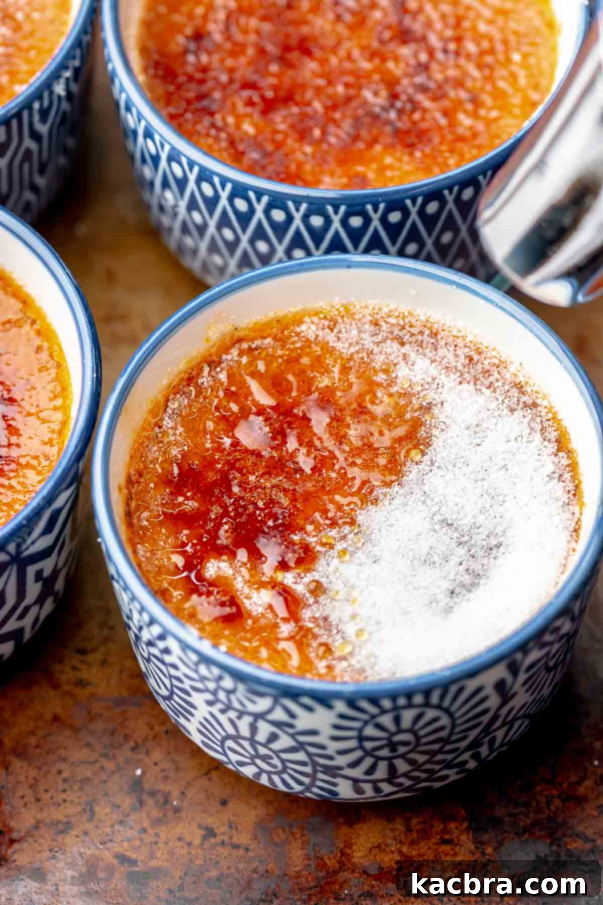 A blow torch caramelizes sugar on top of creme brûlée.