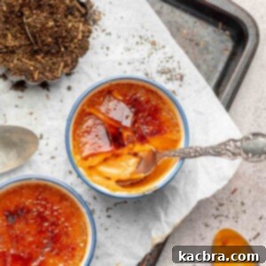 Thai tea creme brûlée with a spoon into the cracked top.