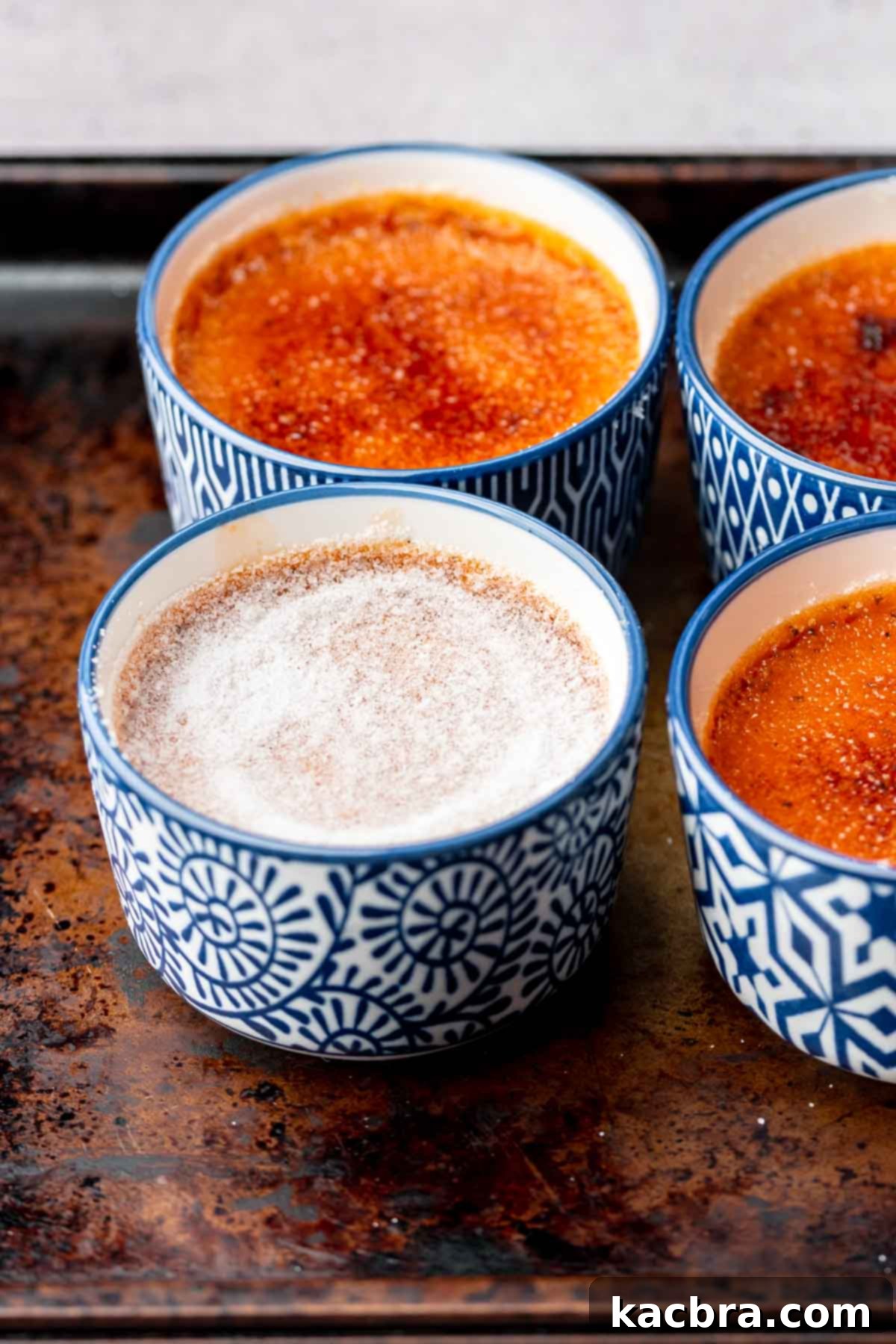 Sugar on top of a baked Thai tea creme brûlée in a ramekin.