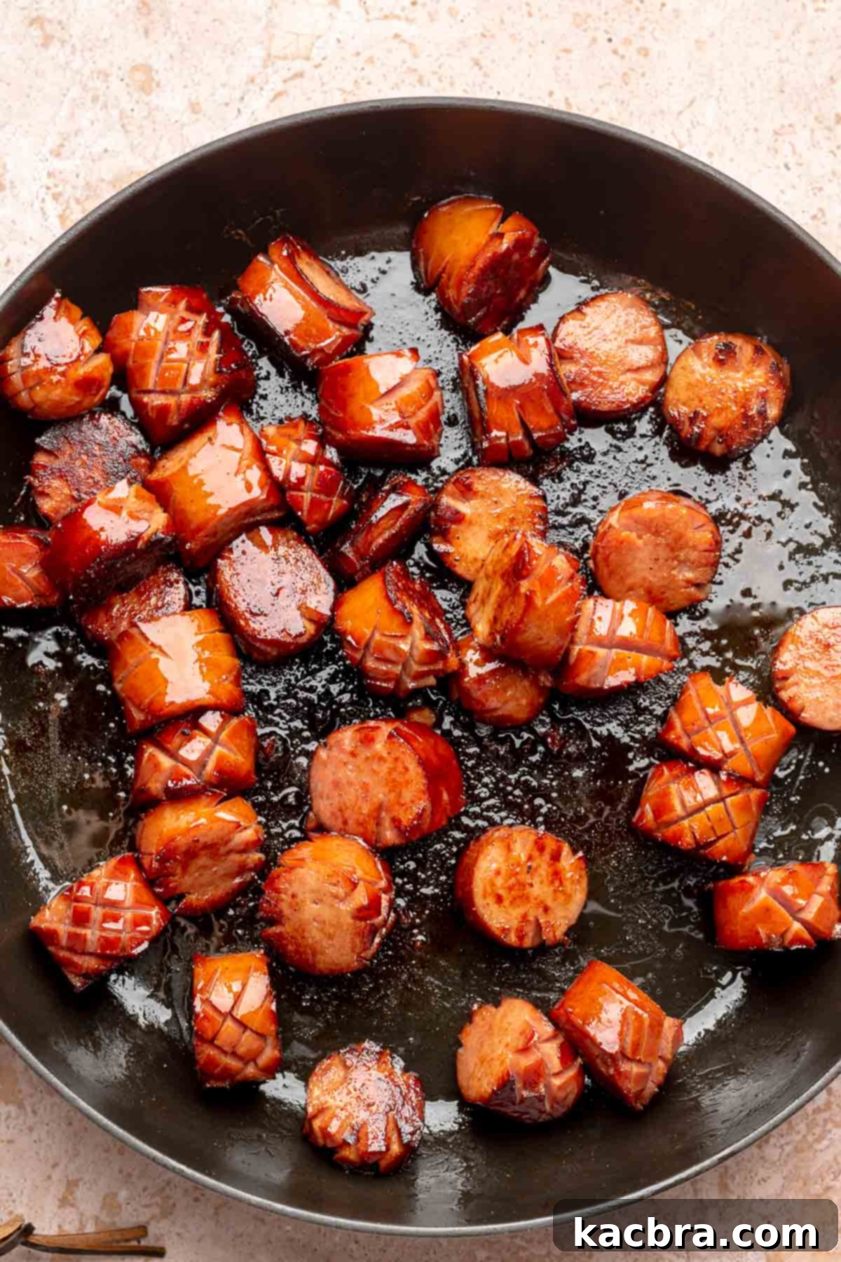 Caramelized kielbasa in a frying pan.