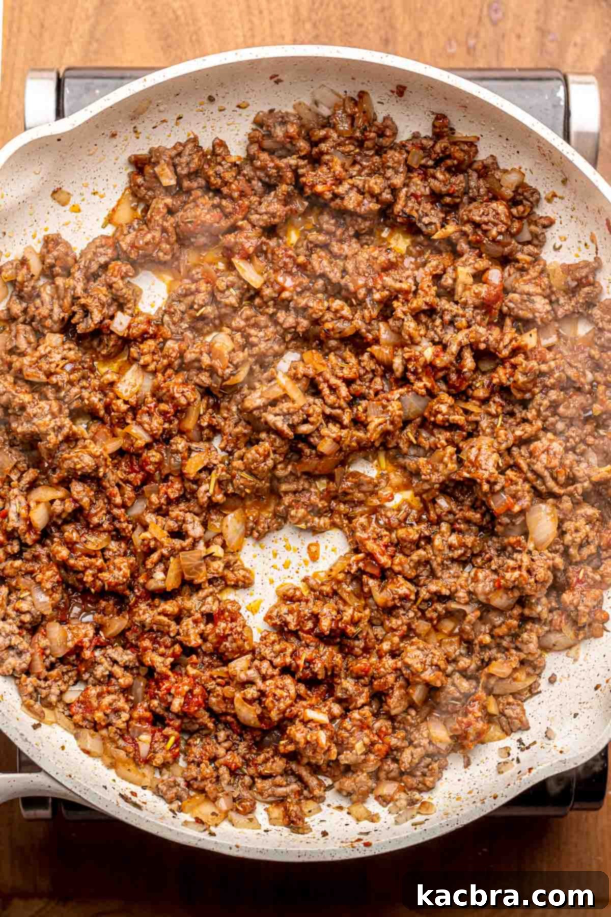 Cooked ground meat and tomato paste in a pan.