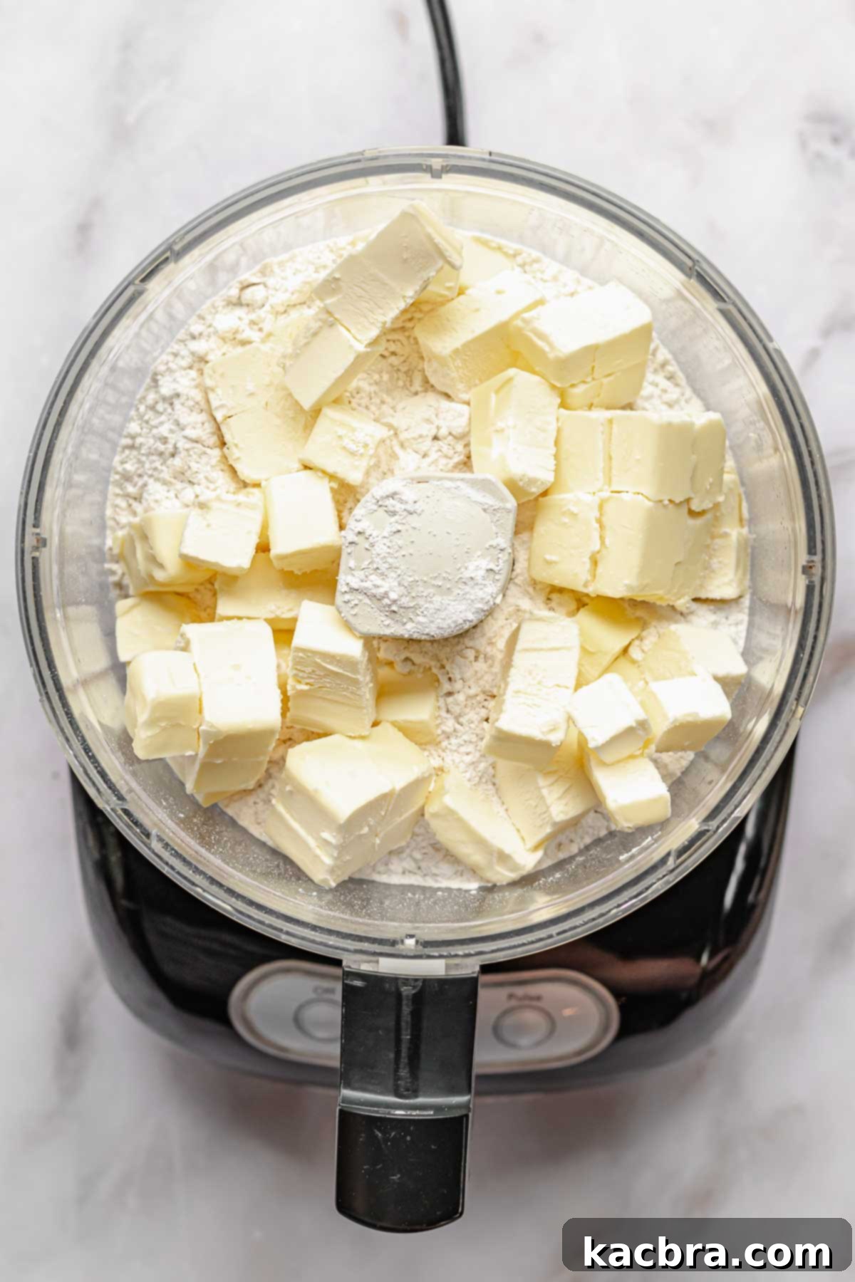 Perfectly Flaky All-Butter Crust 4 Butter cubes in a food processor with flour.