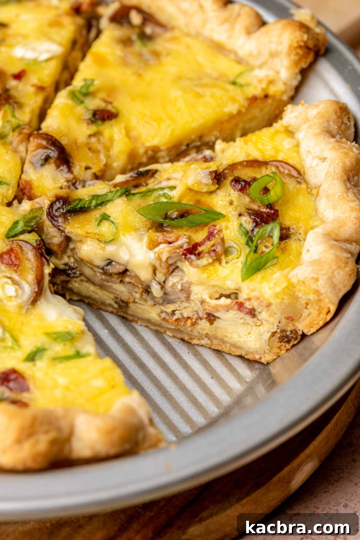 A whole bacon mushroom quiche, freshly sliced and ready to serve.
