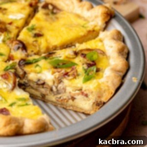 Sliced bacon mushroom quiche in a pie plate, ready to serve.