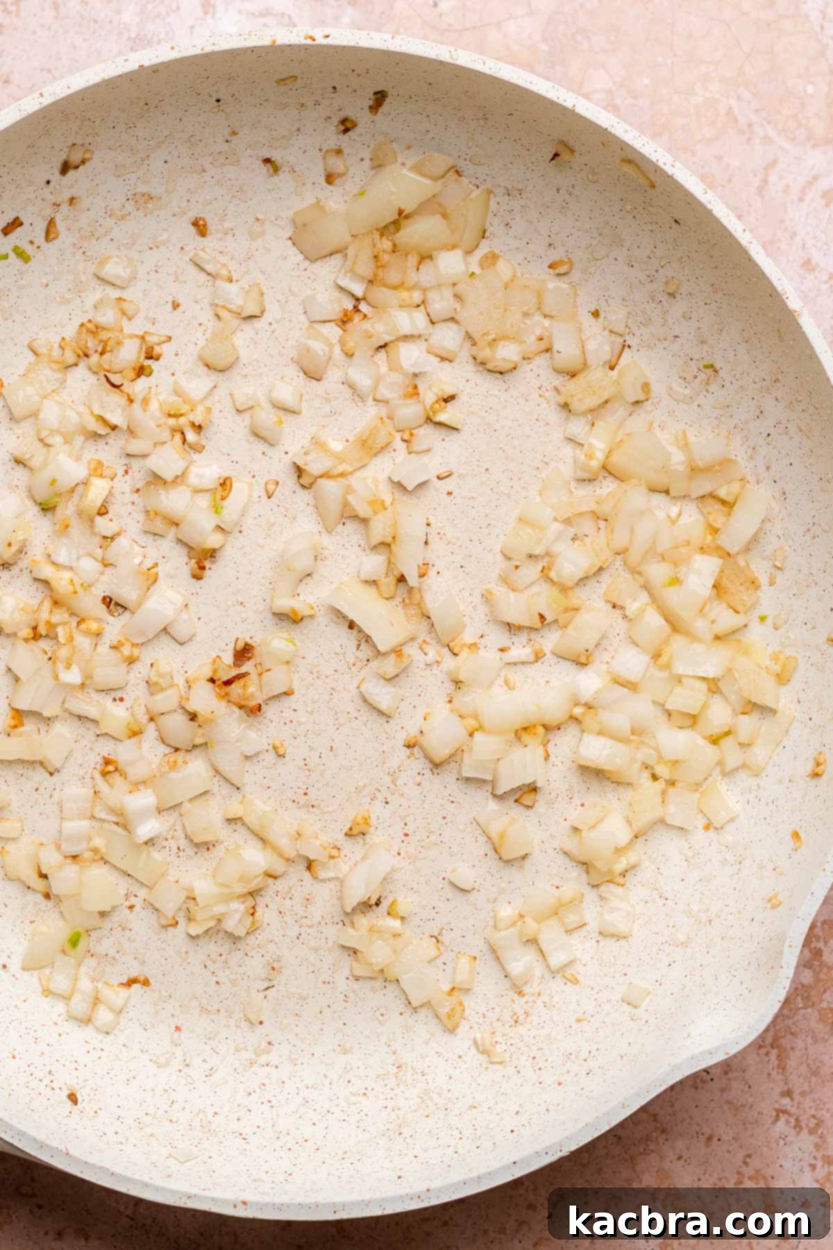 Sautéed onions and garlic in a pan, fragrant and softened.
