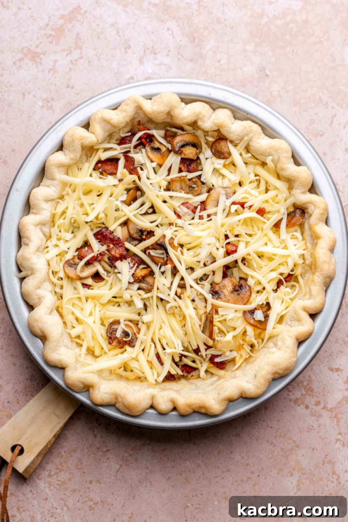 Bacon, mushrooms, cheese, onions, and garlic layered into a par-baked pie crust.