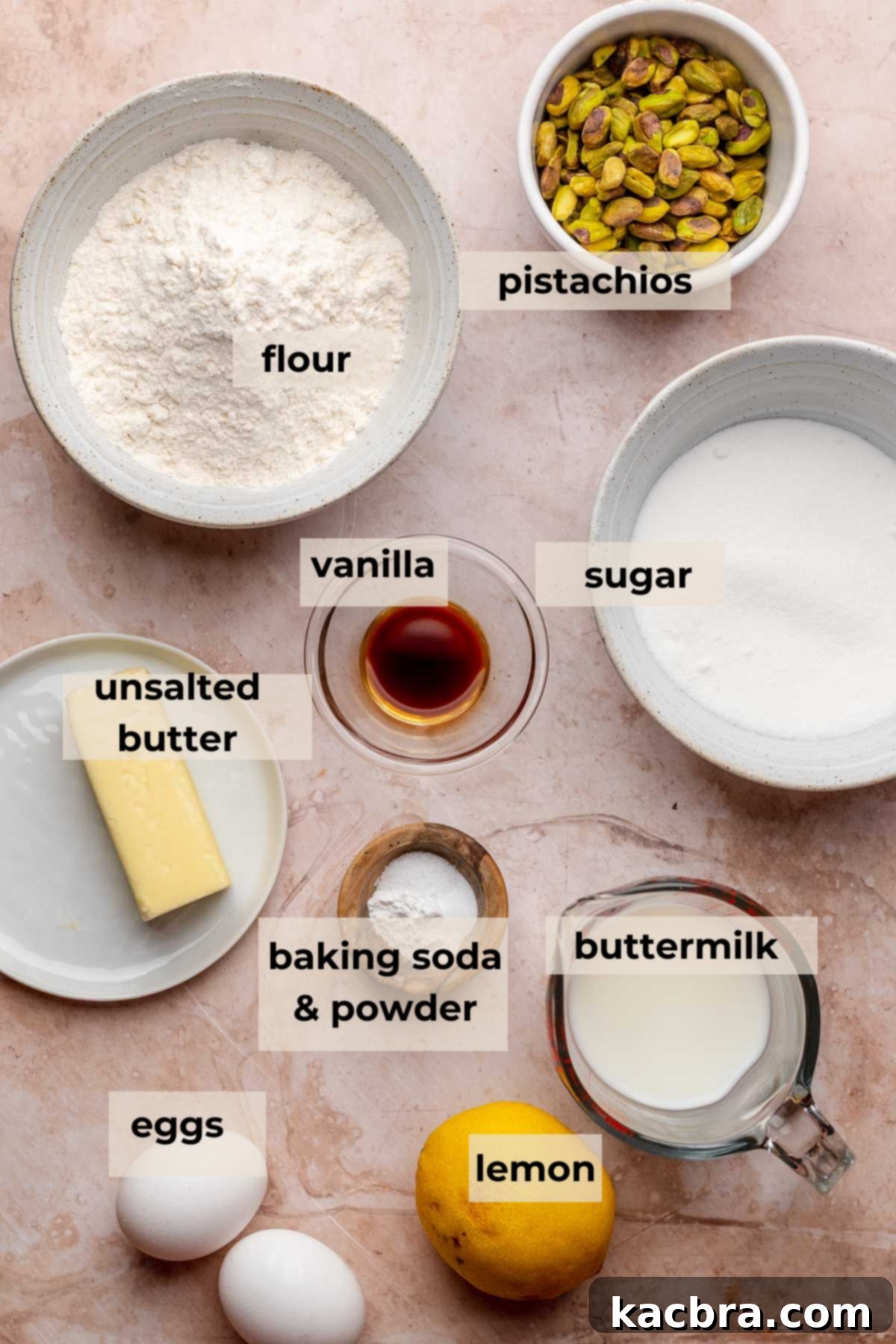 Golden Lemon Pistachio Dream with Honey Mascarpone Cloud 3 A selection of fresh ingredients laid out for baking a lemon pistachio cake, including lemons, pistachios, and butter.