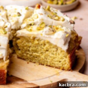Golden Lemon Pistachio Dream with Honey Mascarpone Cloud 17 Sliced lemon pistachio cake on a wooden board.