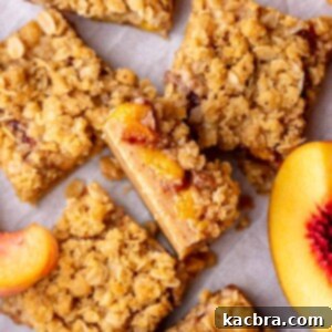 A slice of brown butter peach crumble bars lying on its side, ready to be served.