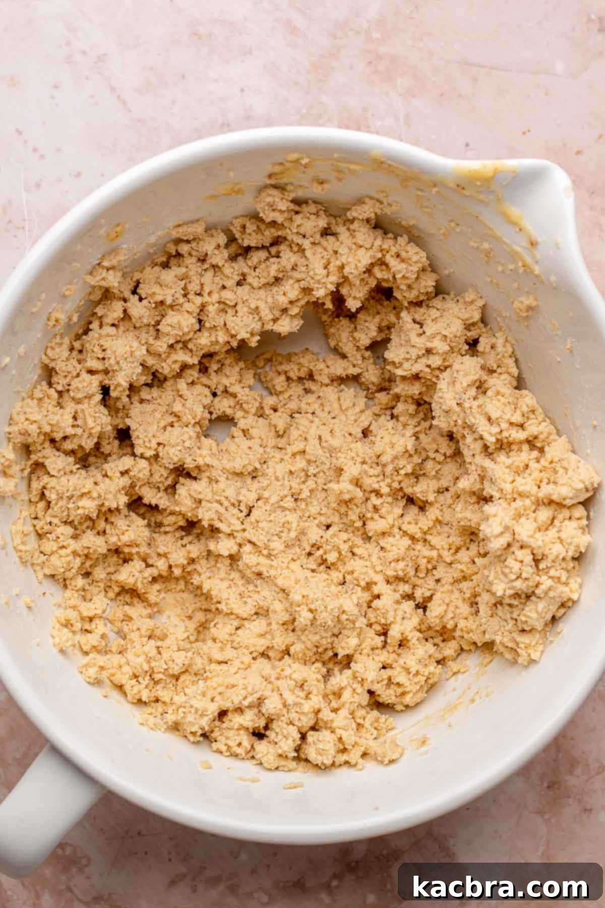 Brown butter shortbread dough in a bowl, just combined and crumbly.