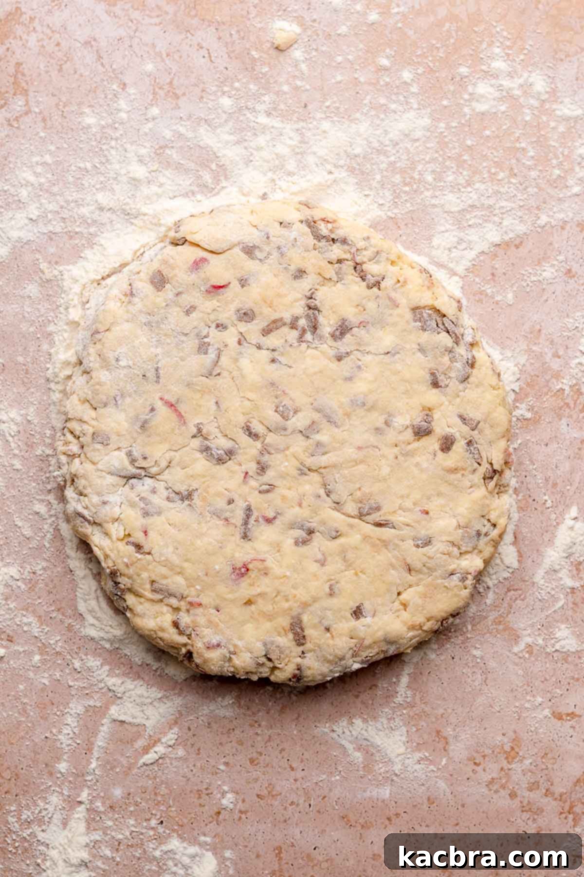 Cinnamon scone dough patted into an 8-inch circle on a lightly floured counter.
