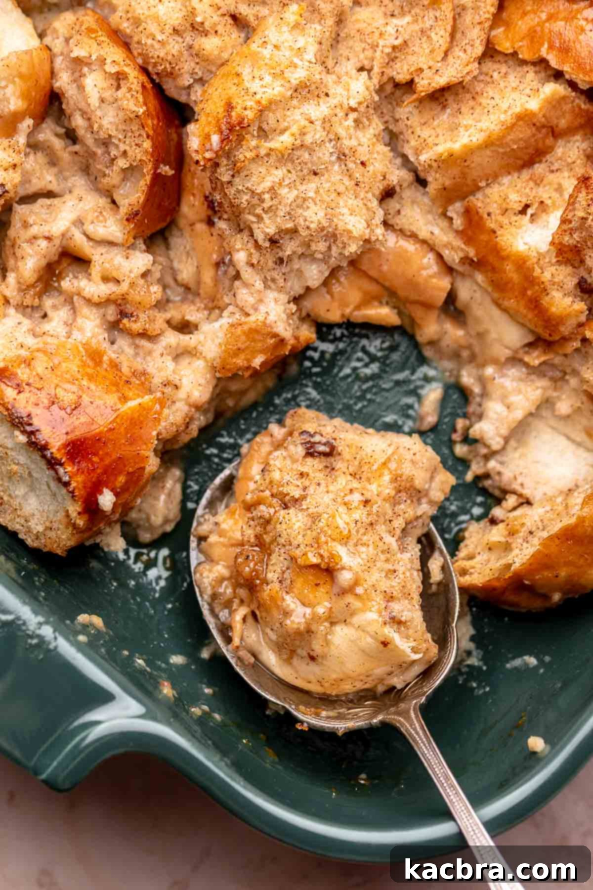 Scoop of french toast casserole in a spoon, ready to be enjoyed.