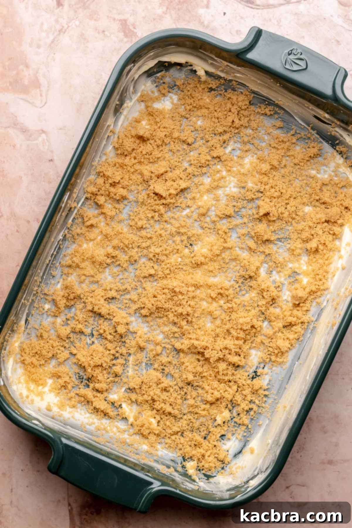 Butter and brown sugar spread into a casserole dish, first step.