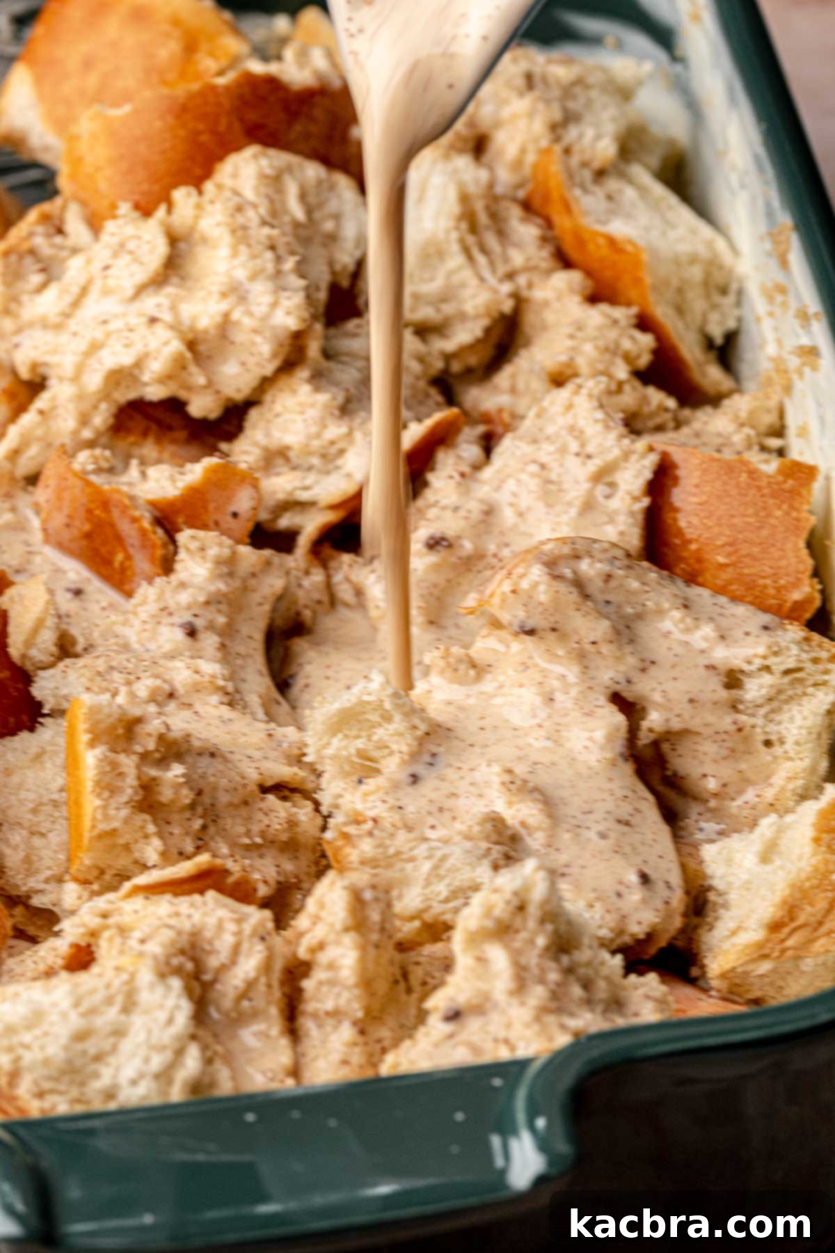 Custard being poured onto pieces of bread, fourth step.