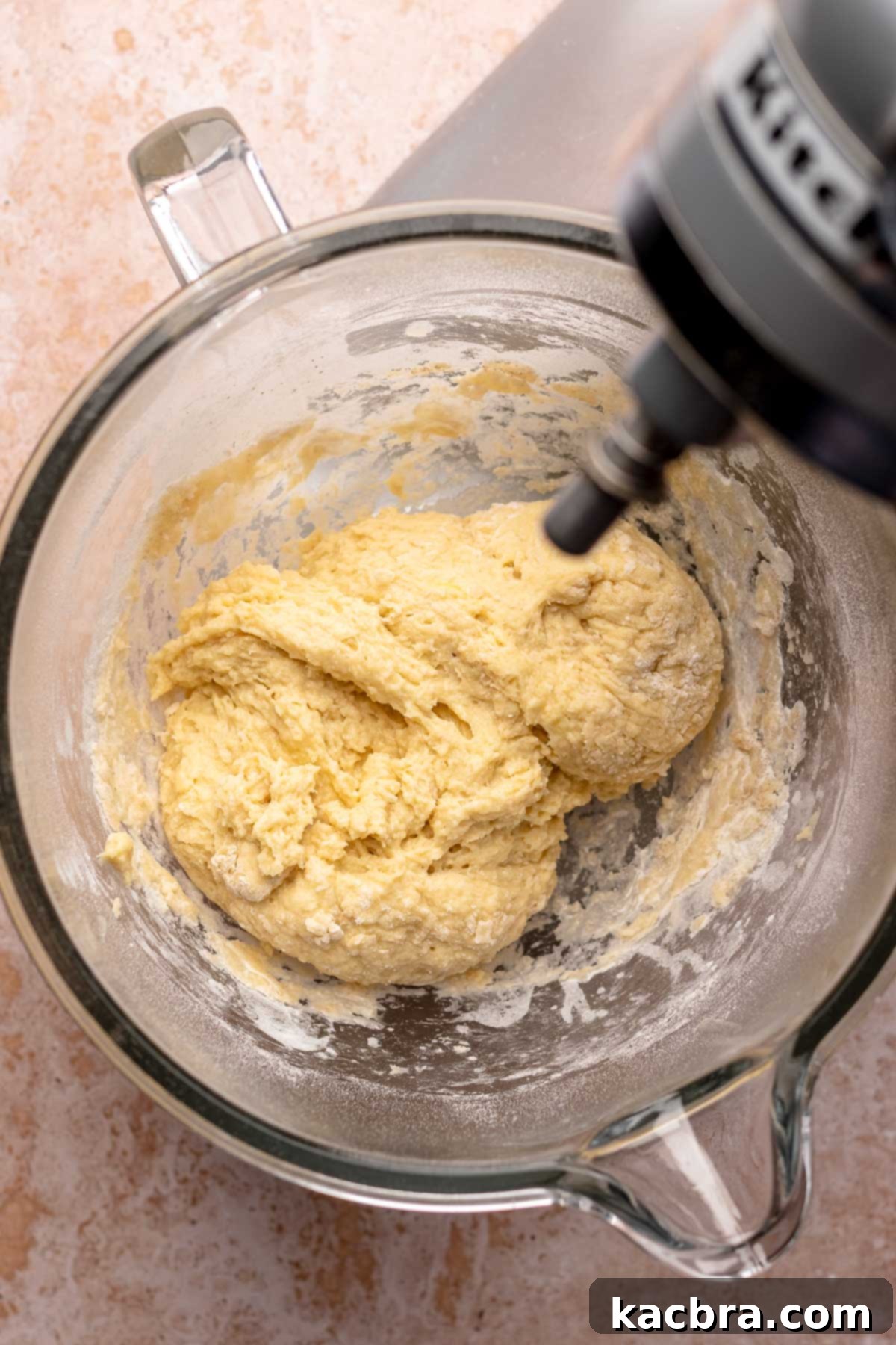 Shaggy dough in a mixing bowl being prepared.