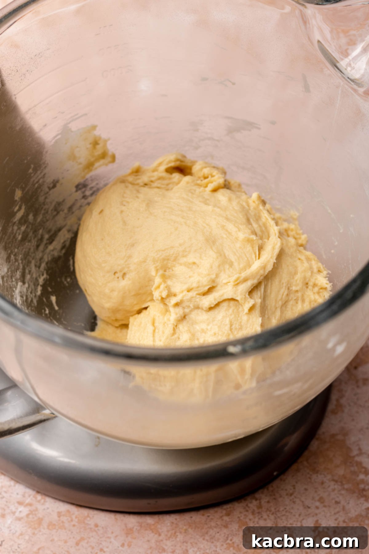 Smooth, elastic dough in a mixing bowl after kneading.