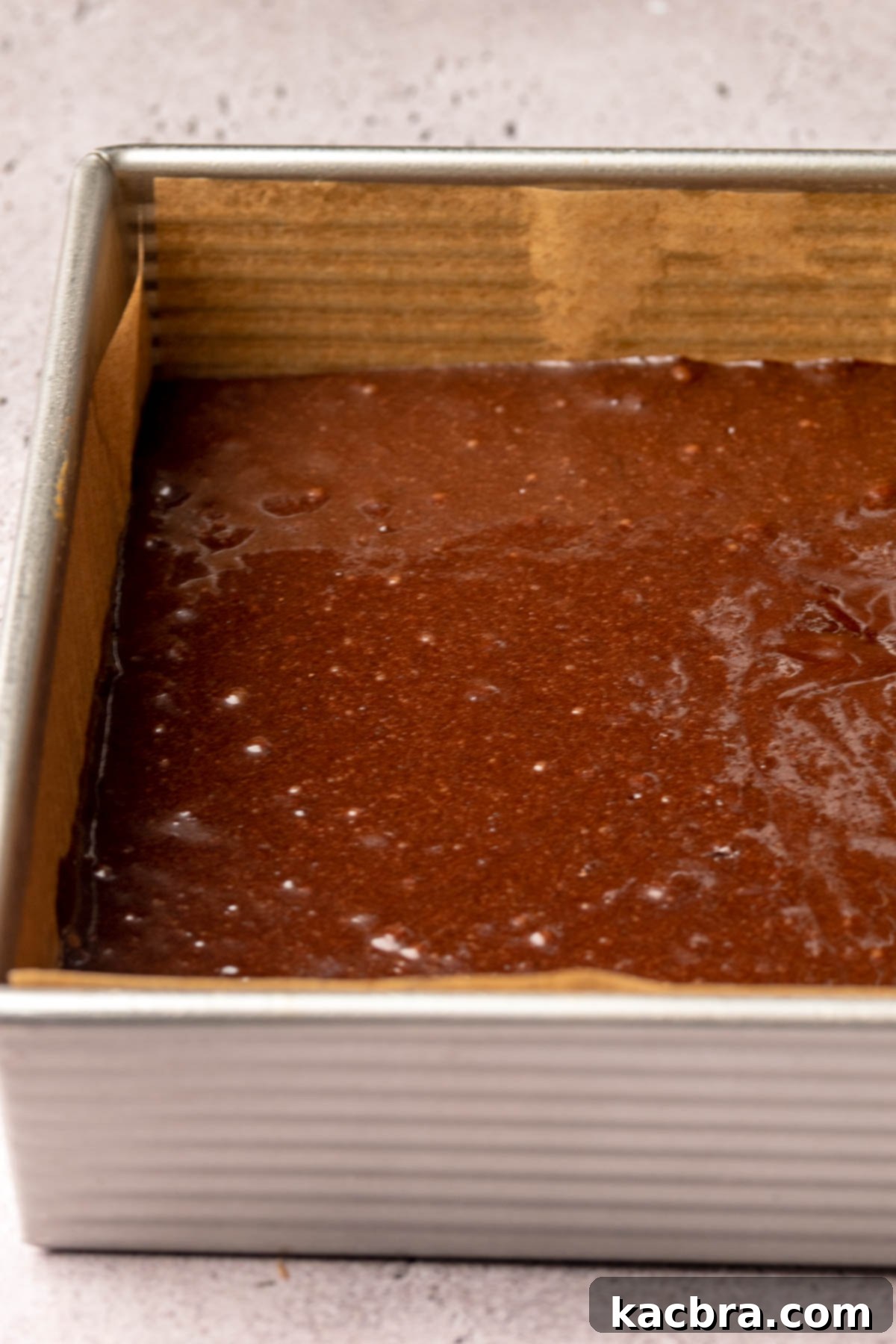 Brownie batter spread into a prepared pan.