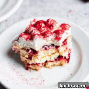 One slice of Cherry Almond Tiramisu on a plate with a bite removed.