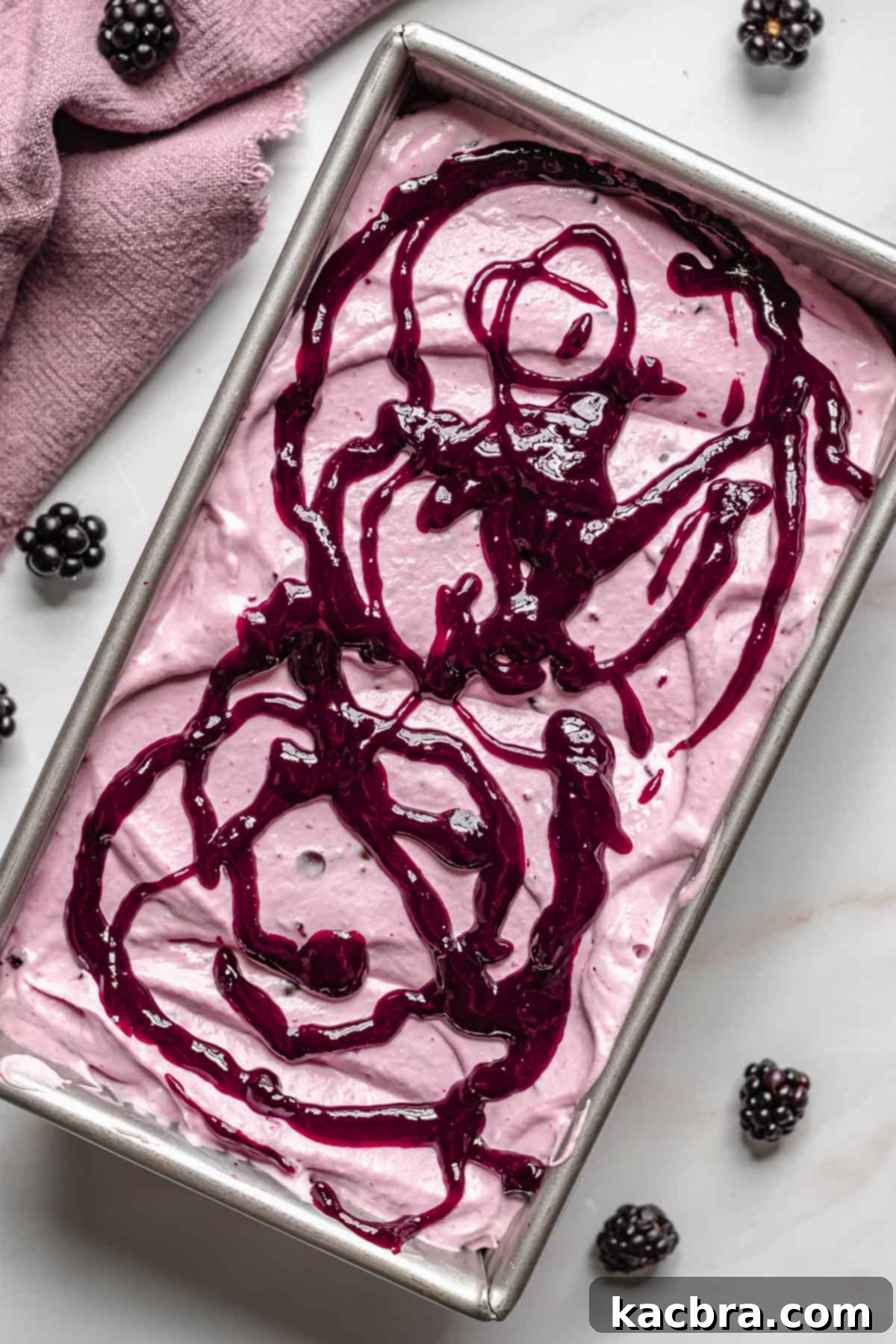 Black raspberry puree drizzled on top of the ice cream.