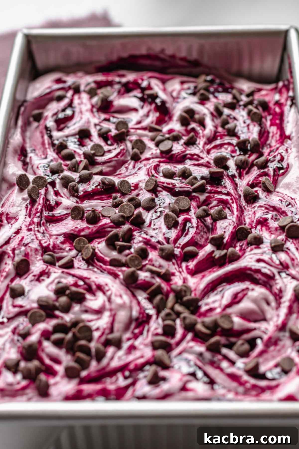 Chocolate chips on top of the swirled and finished ice cream.