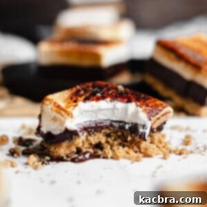 Smores bar with a bite removed and crumbs scattered