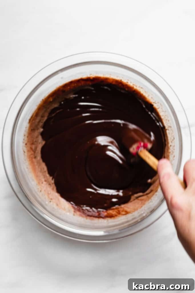 Pouring hot cream over chopped chocolate for ganache.
