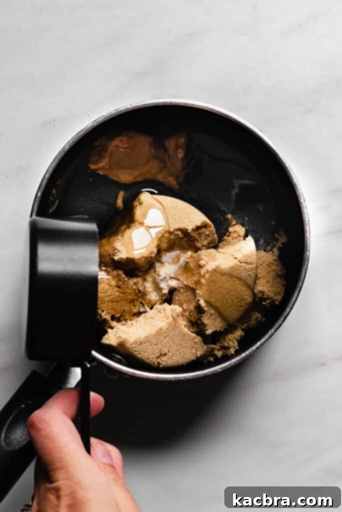 Adding corn syrup to brown sugar and water for marshmallow syrup.