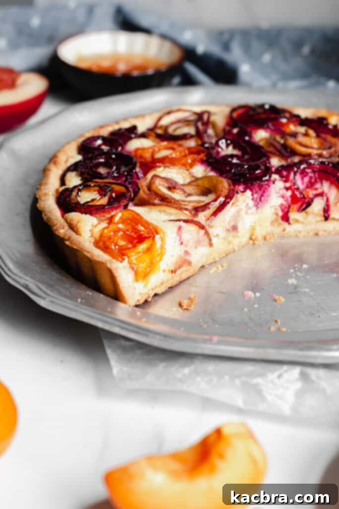 Another perspective of the stone fruit tart, highlighting the vibrant colors and detailed fruit arrangement.