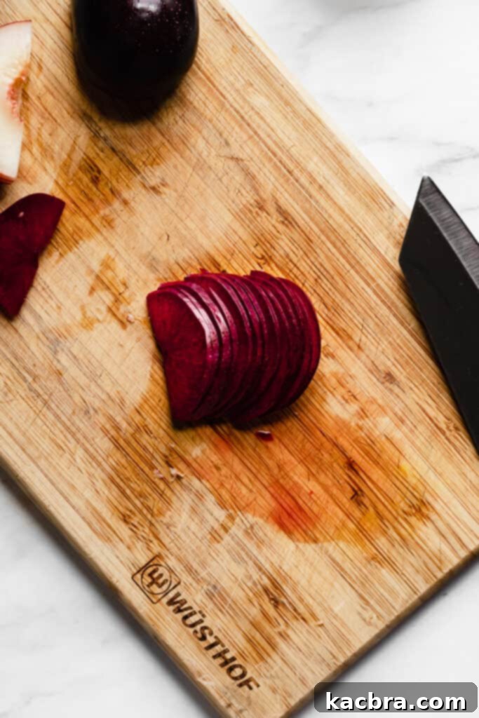 Sliced stone fruit fanned out for rose assembly, step 1.