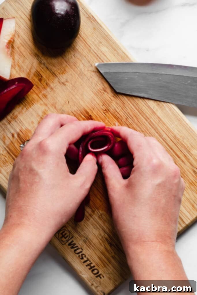 Mid-process of forming a stone fruit rose, showcasing the technique.