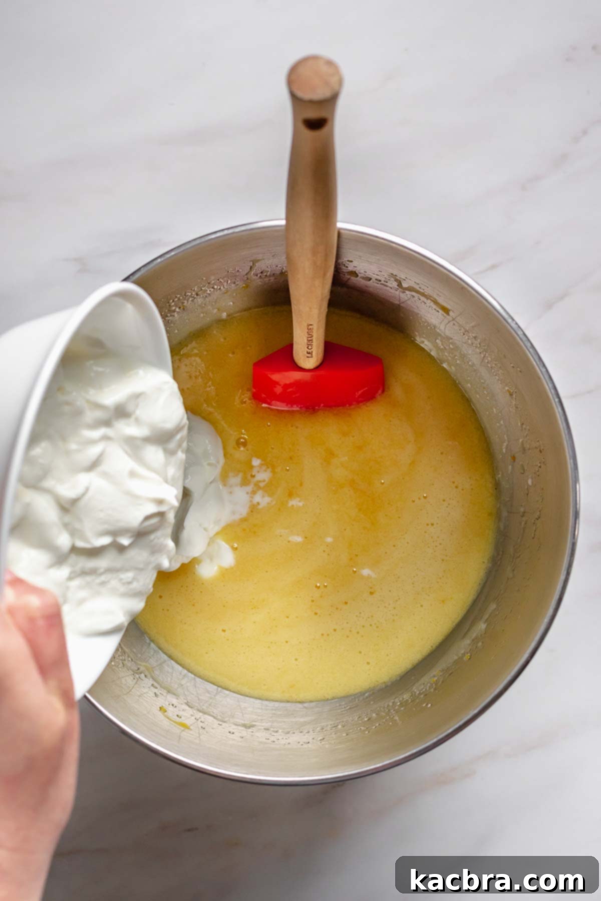 Sour cream pouring into the wet ingredients.