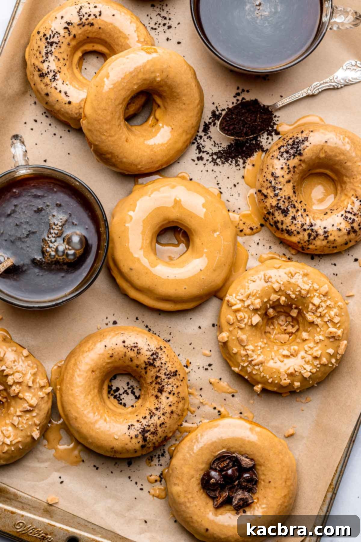 An array of glazed coffee donuts with a cup of coffee next to it, inviting a perfect morning treat.