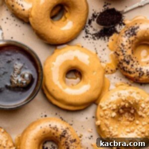 An array of glazed coffee donuts with a cup of coffee next to it.