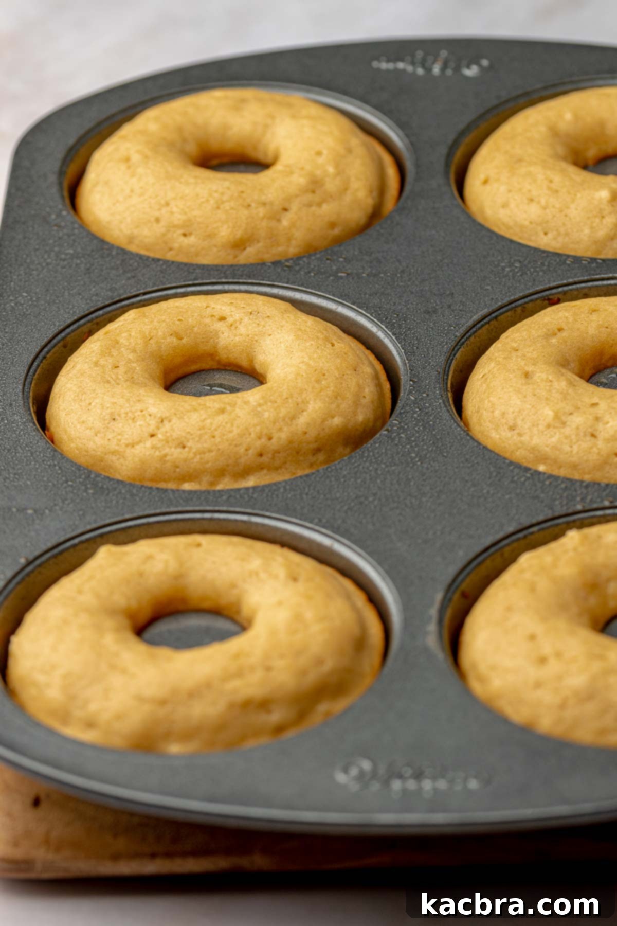 Baked donuts in a donut pan, golden brown and perfectly risen.