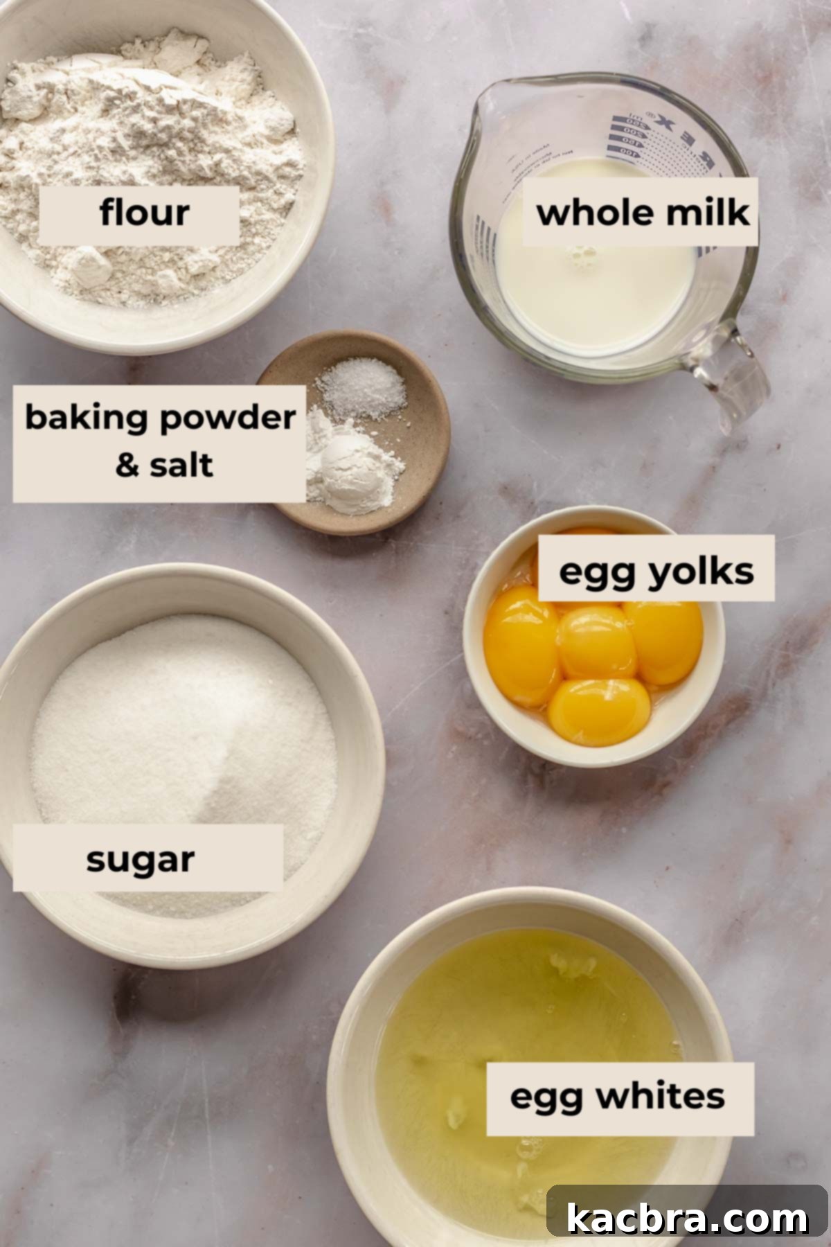 A collection of ingredients laid out for making the sponge cake, including flour, eggs, sugar, and milk.