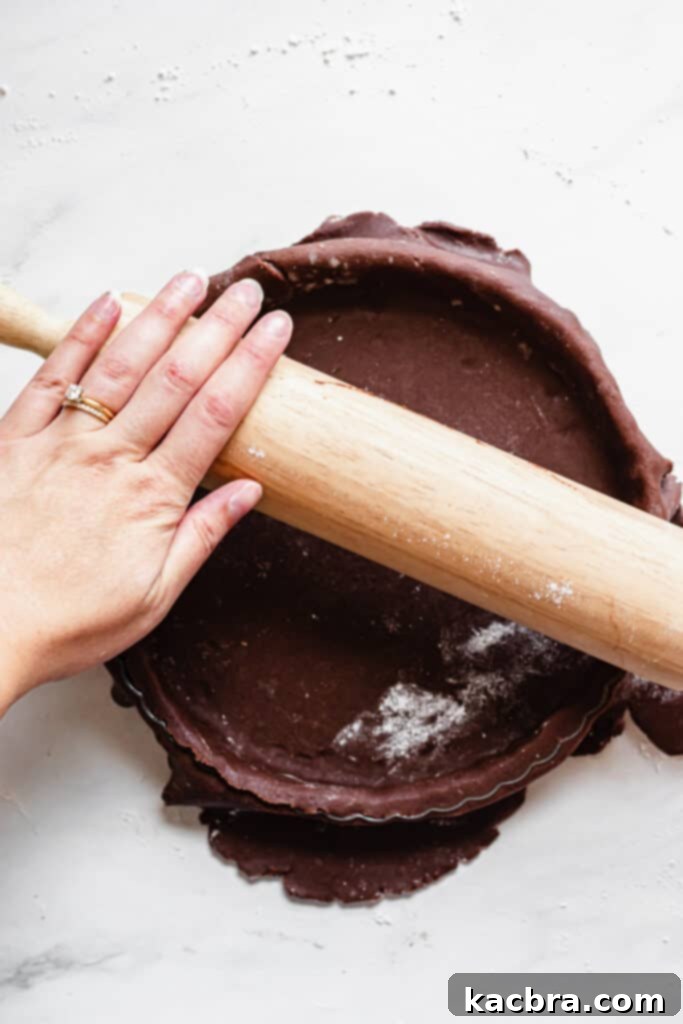 Pressing chocolate tart dough into the pan's edges