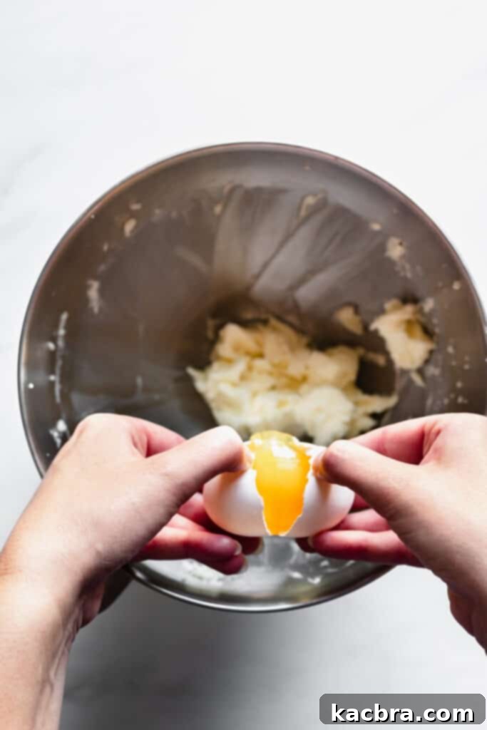 Adding egg to the creamed mixture for chocolate tart crust
