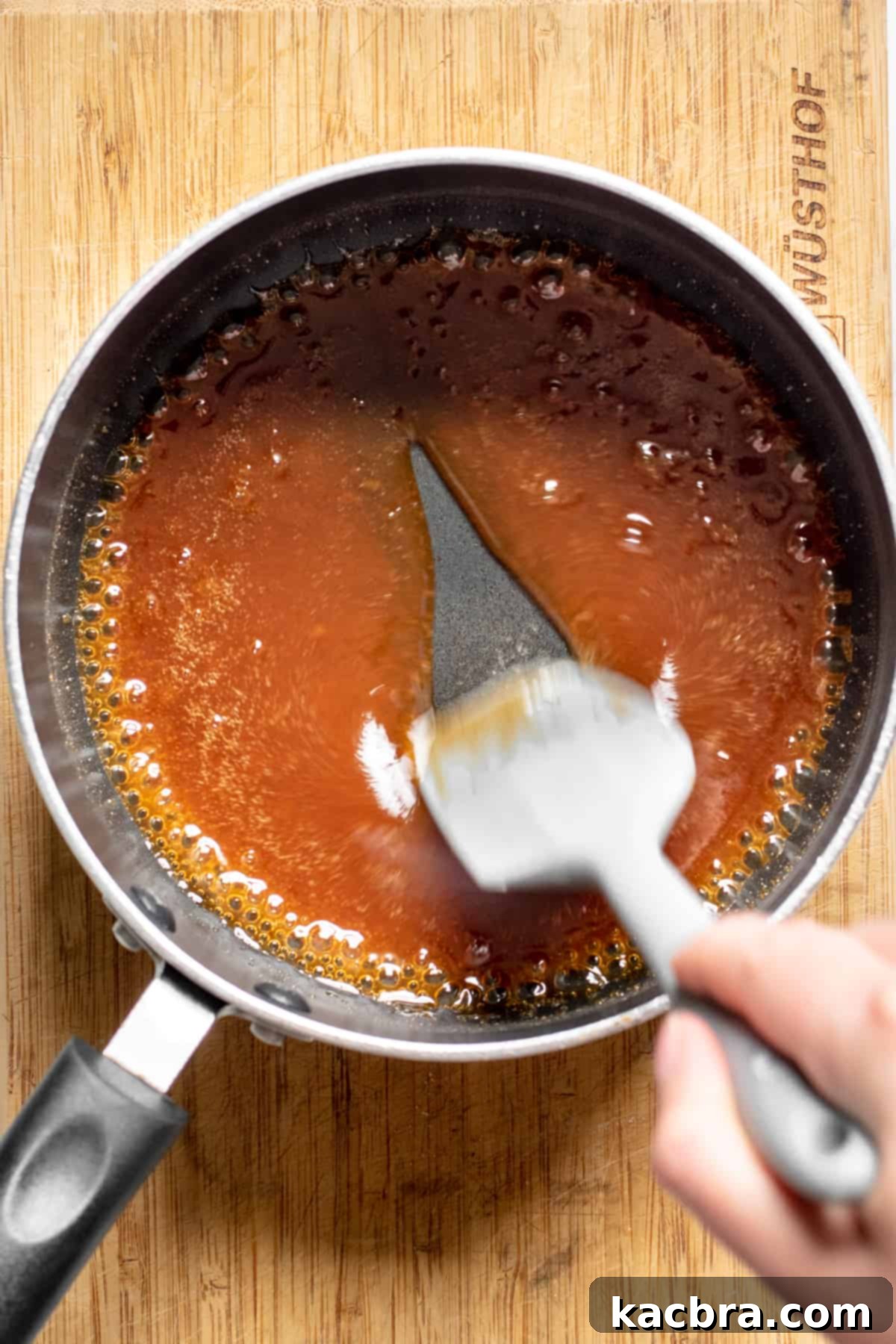 Decadent Caramel Pecan Cheesecake 11 Apple cider simmering in a pot, reducing into a thick, sticky syrup, ready to be transformed into caramel.