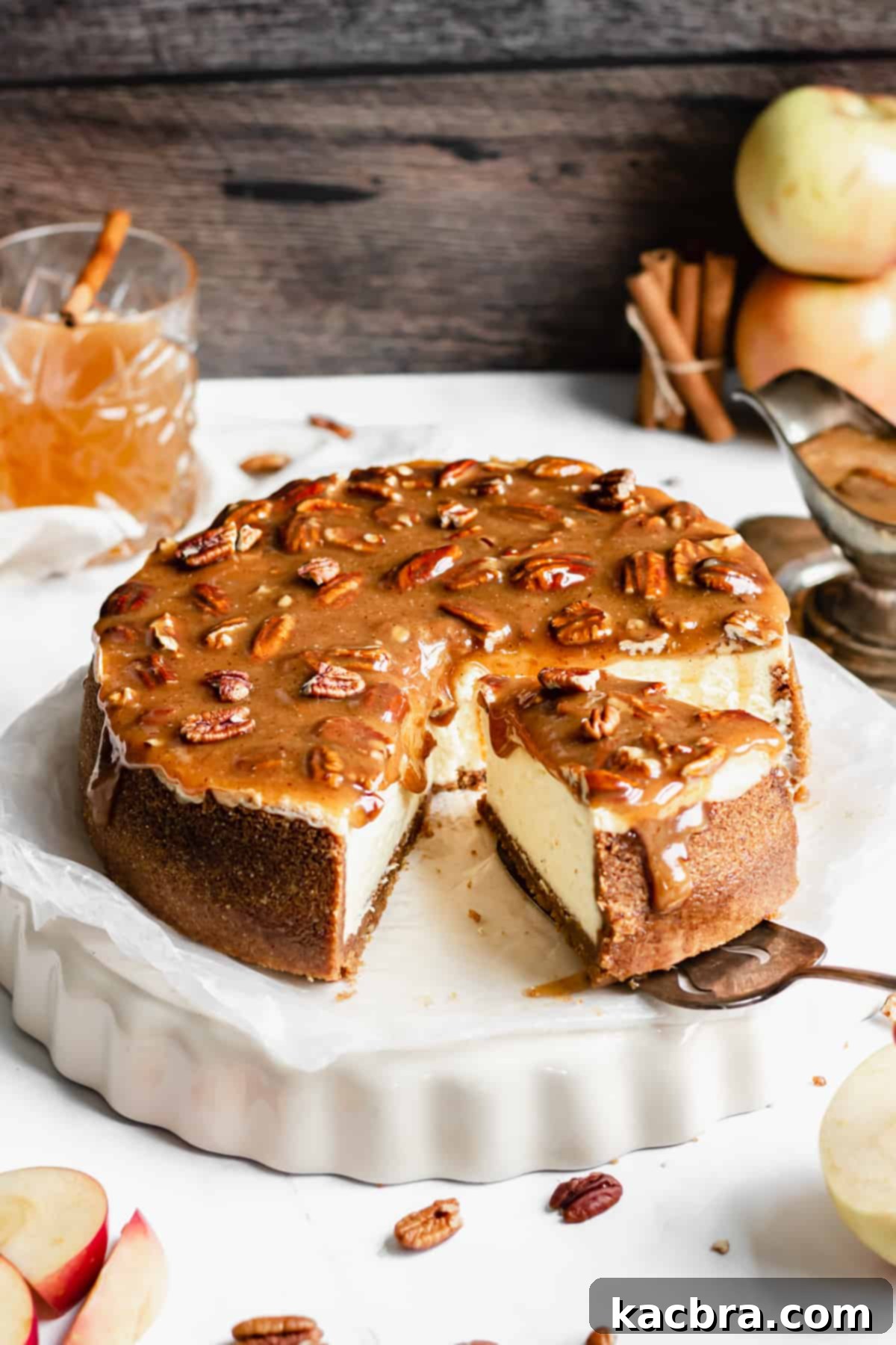 Decadent Caramel Pecan Cheesecake 16 A slice of the decadent caramel pecan cheesecake being carefully removed from the pan, highlighting the golden caramel topping.