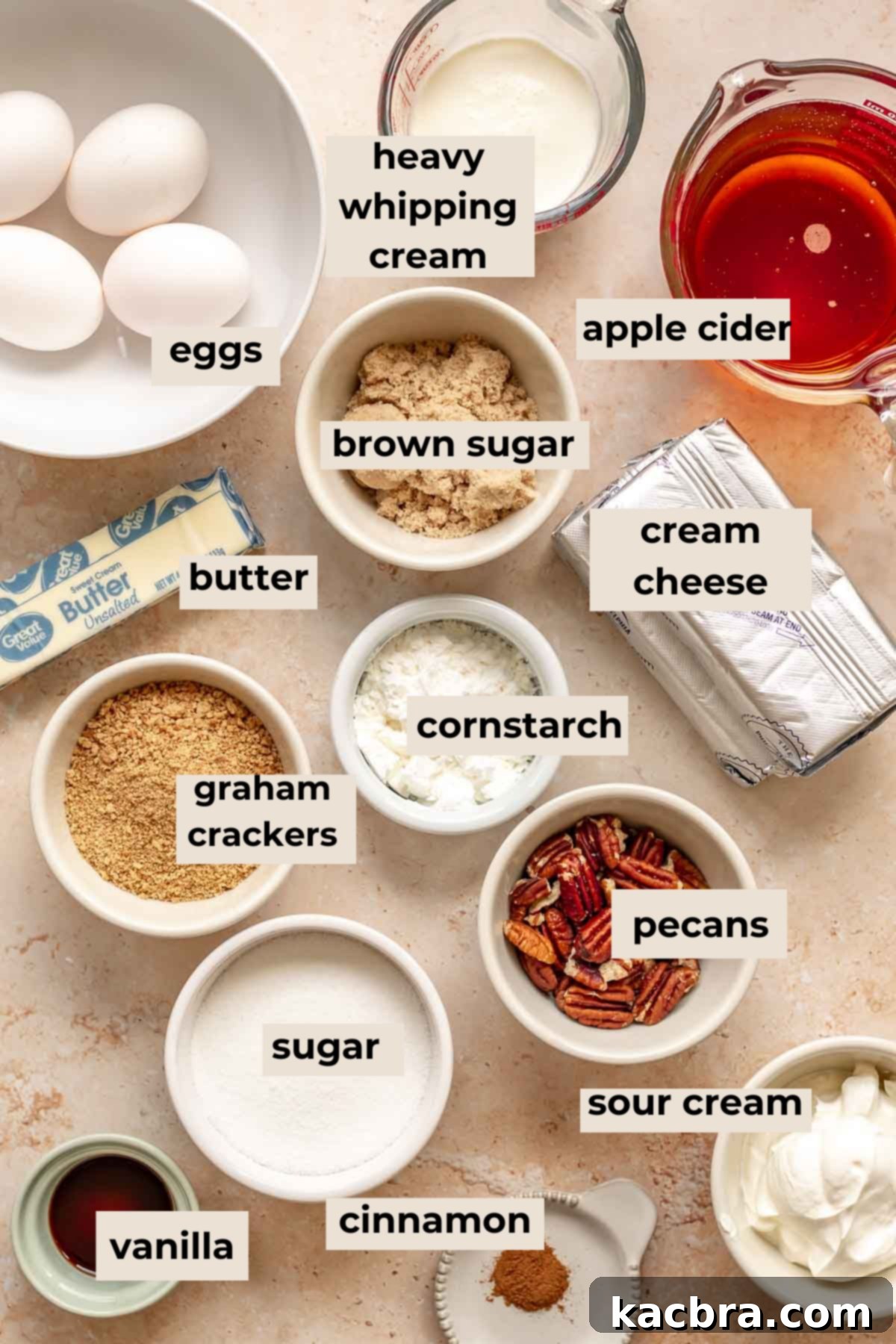 Decadent Caramel Pecan Cheesecake 3 Fresh ingredients laid out for making a delicious caramel pecan cheesecake, including apple cider, graham crackers, pecans, and cream cheese.