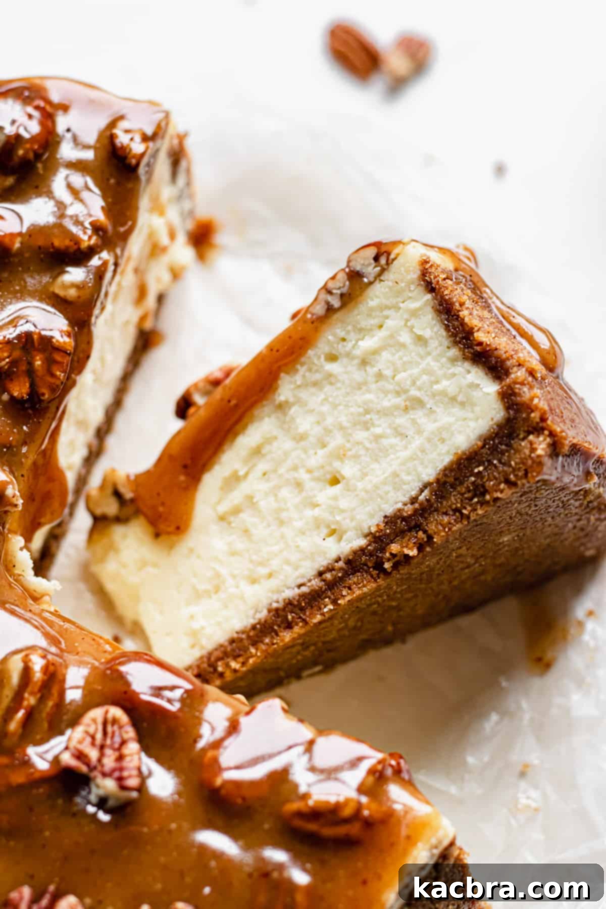 Decadent Caramel Pecan Cheesecake 4 A perfectly baked slice of caramel pecan cheesecake resting on its side, ready to be enjoyed, showcasing its beautiful layers.