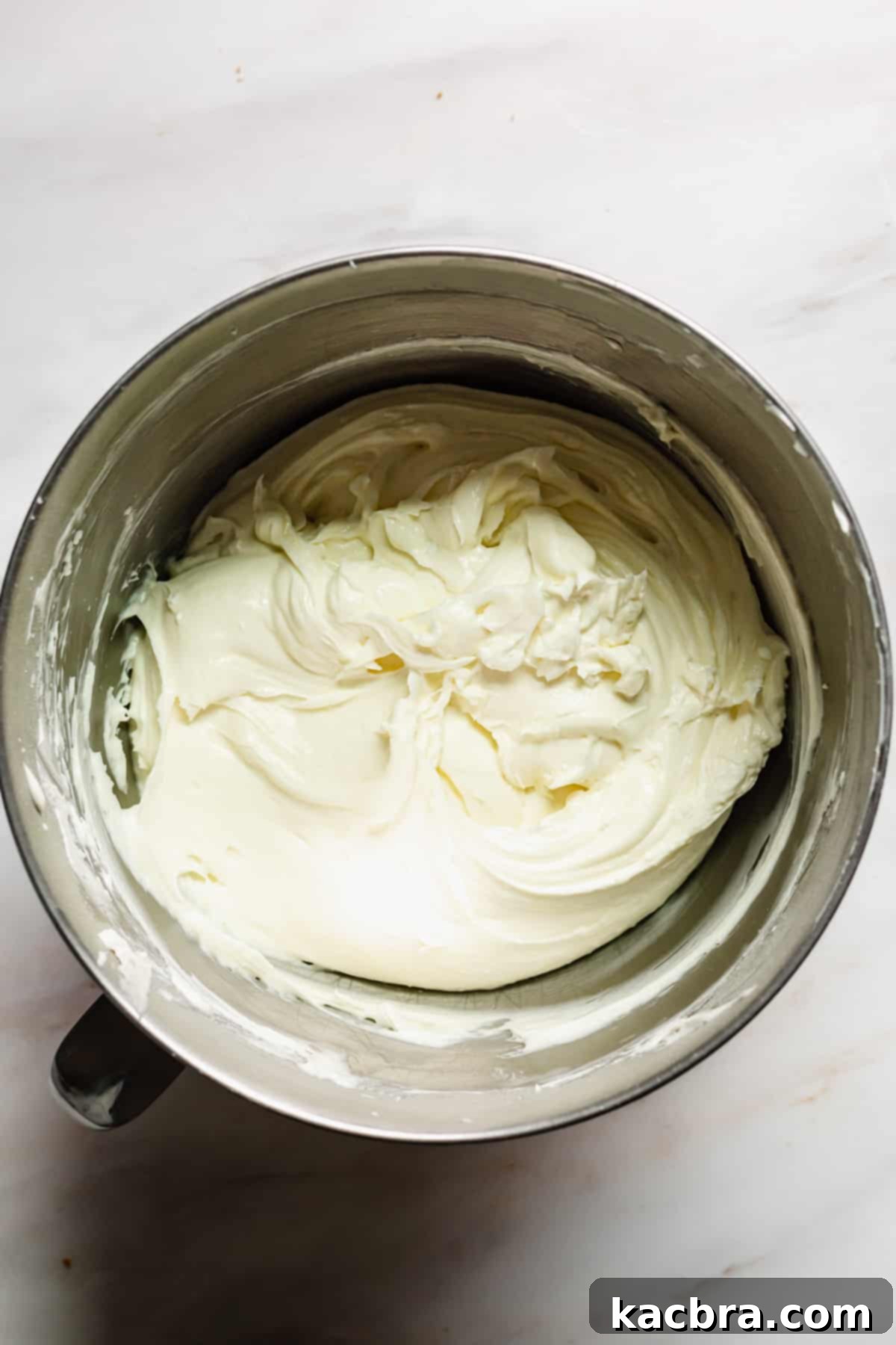 Decadent Caramel Pecan Cheesecake 7 Cream cheese, cornstarch, and granulated sugar are blended together until smooth and creamy in a stand mixer.