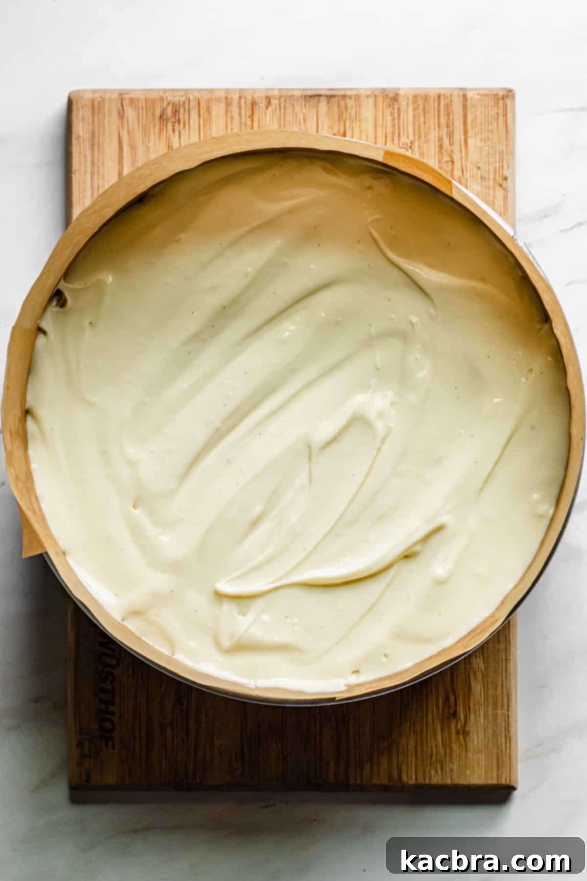 Decadent Caramel Pecan Cheesecake 10 The smooth cheesecake batter poured into the cooled graham cracker pecan crust in a springform pan, ready for the oven.