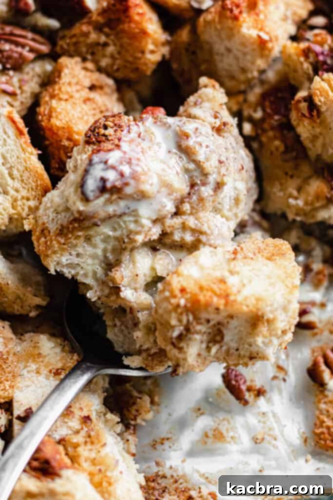 Pecan bread pudding with vanilla sauce drizzled over top, ready to be served.