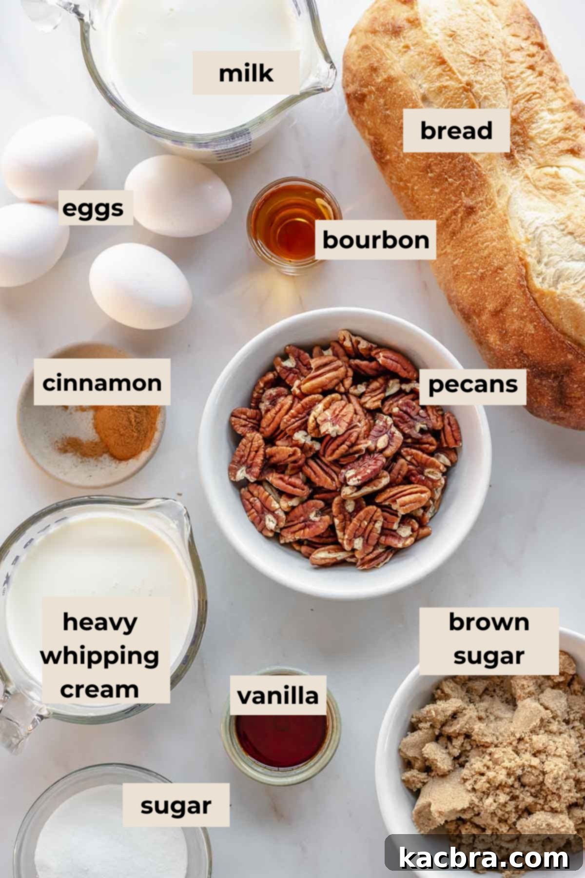 Ingredients for pecan bread pudding with vanilla sauce laid out on a table.